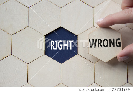 Right or Wrong symbol. Concept word Right or Wrong on wooden comb puzzle. Businessman hand. Beautiful deep blue background. Business and Right or Wrong concept. Copy space Right or Wrong symbol. Concept word Right or Wrong on wooden comb puzzle. Businessman hand. Beautiful deep blue background. Business and Right or Wrong concept. Copy space 127703529