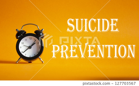 Suicide Prevention symbol. Concept words Suicide Prevention on Beautiful orange background with alarm clock. Medicine and Suicide Prevention concept. Copy space. Suicide Prevention symbol. Concept words Suicide Prevention on Beautiful orange background with alarm clock. Medicine and Suicide Prevention concept. Copy space. 127703567