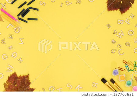 Background on the topic of education, school background. Alarm clock on a yellow background top view 127703681