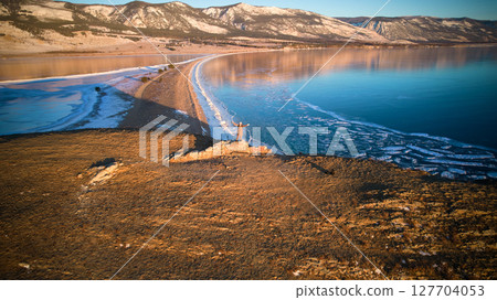 A woman is traveling on Lake Baikal. Beautiful mountain landscape from the air 127704053