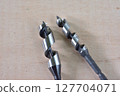 Woodworking drill on a wooden board 127704071