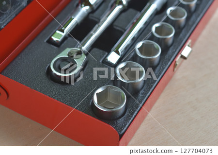 Socket wrench in a toolbox 127704073