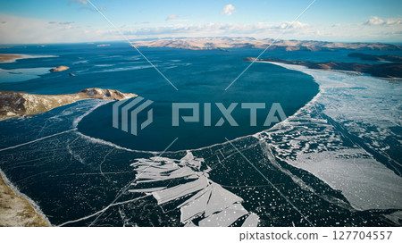 Lake Baikal in December. View of the freezing Muhur Bay from the air. 127704557