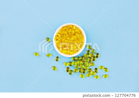 Yellow capsules with Vitamin D3. Healthy and medical concept, sunshine vitamin. Yellow capsules with Vitamin D3. Healthy and medical concept, sunshine vitamin. 127704776