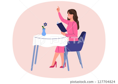 Woman restaurant visitor raises hand to call waiter and place order, sits at table and holds menu 127704824