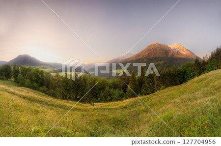 Meadow with road and bench during sunset in Berchtesgaden National Park 127704956