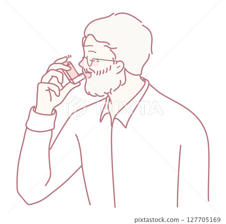 A Man Using an Inhaler for Relief from Asthma Symptoms and Managing His Condition Effectively A Man Using an Inhaler for Relief from Asthma Symptoms and Managing His Condition Effectively 127705169
