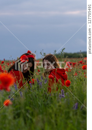 Women in Red in a Poppy Field 127705491