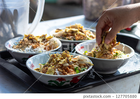 Savory Soto Ayam Dish with Various Toppings Savory Soto Ayam Dish with Various Toppings 127705880