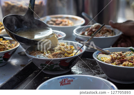 Pouring Hot Broth into Indonesian Soto Bowls at a Stall at Mataram, Lombok, Indonesia - September 1, 2024 127705893