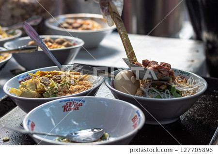 Preparing Bowls of Traditional Indonesian Soto Soup Preparing Bowls of Traditional Indonesian Soto Soup 127705896