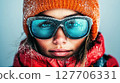 Mountain adventure with a young woman wearing winter gear in snowy conditions, showcasing determination and style while exploring the outdoors 127706331