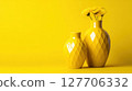 Bright yellow vases with flowers create a cheerful atmosphere in a minimalist setting 127706332
