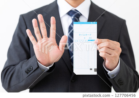 A middle-aged male businessman in a suit holding a time card and showing five fingers A middle-aged male businessman in a suit holding a time card and showing five fingers 127706456