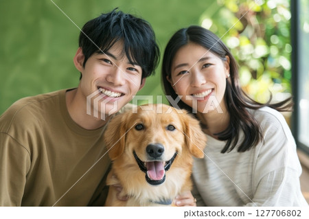 Smiling family and happy time spent with their beloved dog Smiling family and happy time spent with their beloved dog 127706802