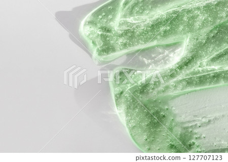 Green cosmetic smear gel texture on a white background 127707123