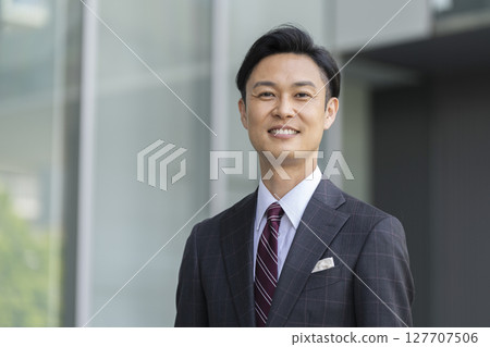A businessman in his 40s smiling at the camera A businessman in his 40s smiling at the camera 127707506