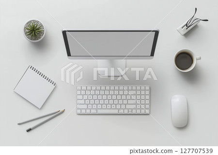 Desktop monitor, white keyboard and coffee cup placed on a white wooden table Desktop monitor, white keyboard and coffee cup placed on a white wooden table 127707539