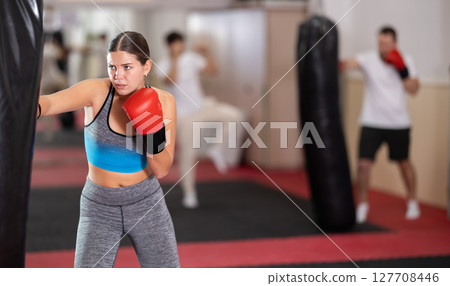 Woman training in boxing section Woman training in boxing section 127708446