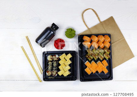 Japanese food delivery. Big sushi set in plastic box. 127708495