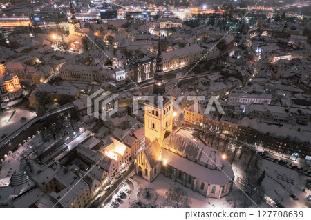 Aerial night View of Tallinn in winter, roofs are covered with snow, Christmas mood Aerial night View of Tallinn in winter, roofs are covered with snow, Christmas mood 127708639