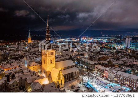 Aerial night View of Tallinn in winter, roofs are covered with snow, Christmas mood Aerial night View of Tallinn in winter, roofs are covered with snow, Christmas mood 127708661