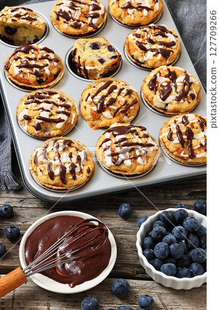 tasty blueberry muffins with lemon chocolate glaze tasty blueberry muffins with lemon chocolate glaze 127709266