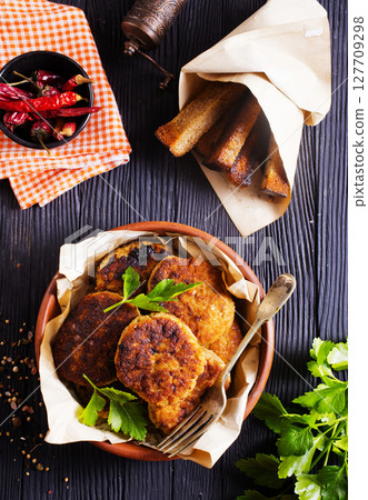 fried cutlets on brown bowl fried cutlets on brown bowl 127709298