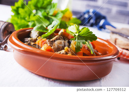 Fried chicken liver with onions and carrots 127709312