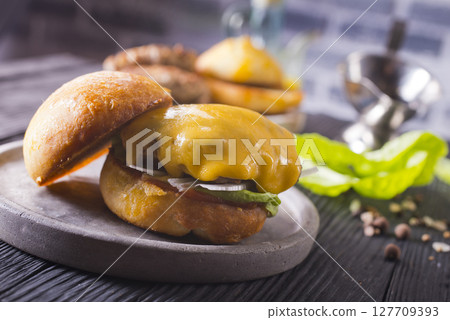 Close up cheese burger on wooden background. 127709393