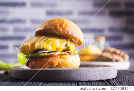 Close up cheese burger on wooden background. 127709394