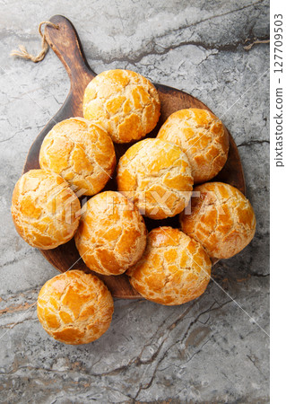 Pineapple buns Bolo Bao are a Chinese bakery classic a fluffy, milk bread closeup. Vertical top view Pineapple buns Bolo Bao are a Chinese bakery classic a fluffy, milk bread closeup. Vertical top view 127709503