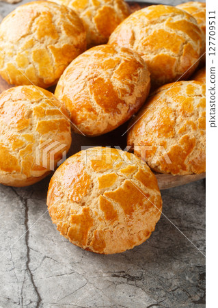 Pineapple buns Bo Lo Bao is a kind of sweet bun from Hong Kong the name refers to the look of the characteristic topping closeup on the table. Vertical 127709511