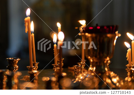 Candles burning in an Orthodox church. Candles burning in an Orthodox church. 127710143