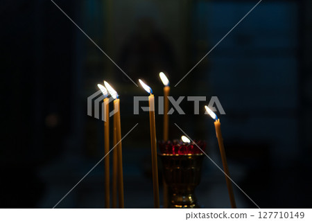 Candles burning in an Orthodox church. 127710149
