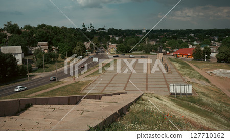 The open road invites travelers into the heart of a serene town. 127710162