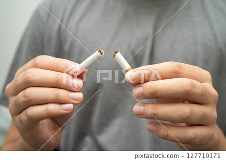Quit smoking, Asian teenage man breaking destroy cigarette in hand. 127710171