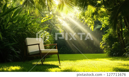 Natural light filtering through trees illuminates a single chair in a lush garden during the morning 127711676