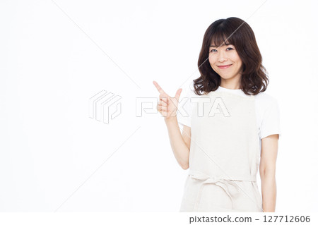 Housewife raising index finger Housewife raising index finger 127712606