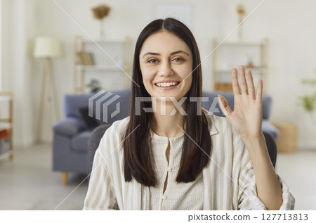 Portrait Of Happy Woman Waving On Video Call At Home Portrait Of Happy Woman Waving On Video Call At Home 127713813
