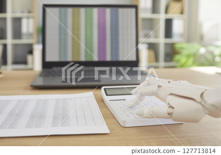 Future auto employee robotic hand, mechanical arm on calculator, accounting machining processes Future auto employee robotic hand, mechanical arm on calculator, accounting machining processes 127713814