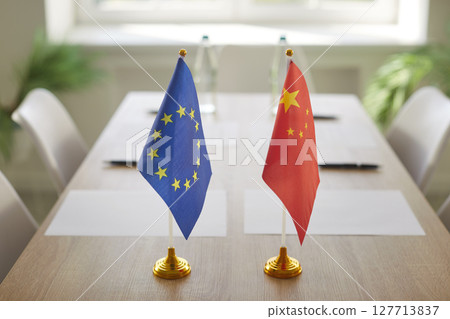 Flags of China and European Union on wooden table on international negotiations Flags of China and European Union on wooden table on international negotiations 127713837