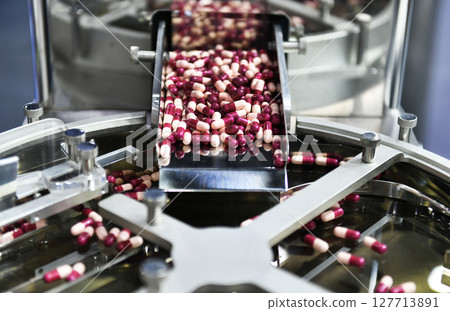 Medicine capsule pill in production line at medical factory, Industrial pharmaceutical concept. 127713891