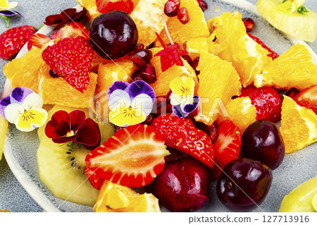 Fruit salad decorated with flowers. 127713916