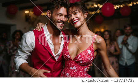 A man and a woman dancing at a party 127714722