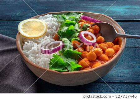 Chana masala, chickpea curry, traditional Indian dish. Healthy Indian food Chana masala, chickpea curry, traditional Indian dish. Healthy Indian food 127717440