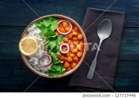 Chana masala, chickpea curry, traditional Indian dish, overhead flat lay shot Chana masala, chickpea curry, traditional Indian dish, overhead flat lay shot 127717446