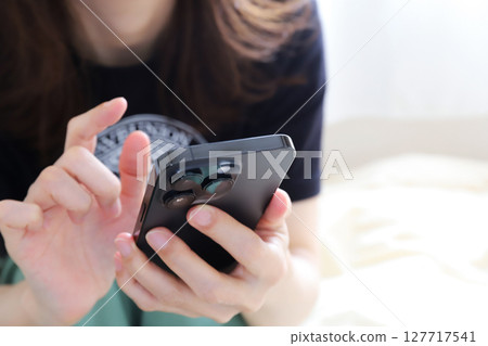 A woman using a smartphone A woman using a smartphone 127717541