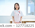 A woman in a white coat and apron 127718225