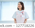 A woman in a white coat and apron 127718226
